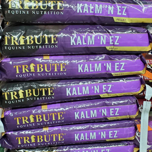 Stacks of purple and yellow horse feed bags labeled 