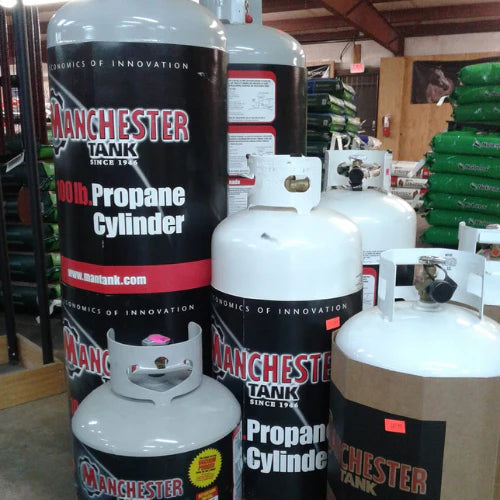 A stack of various-sized propane tanks displayed in a store, each labeled 