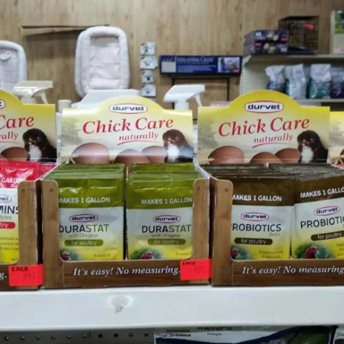 Store shelf displaying various poultry care products, including 
